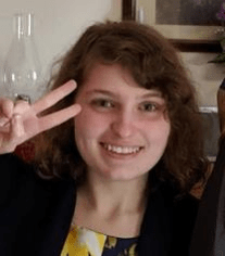 it's me!  I'm smiling and holding up a peace sign.